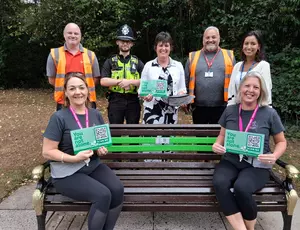 Mental Health Support Walking and Talking Group Leaders sit on the newly installed ‘buddy bench’ in Malvern park.