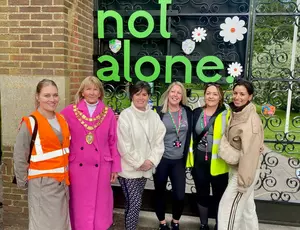 Mayor, walking group leader, leader of SMBC stood in front of You are not alone sign
