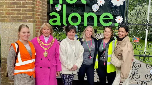 Mayor, walking group leader, leader of SMBC stood in front of You are not alone sign