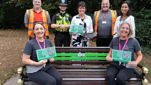 Mental Health Support Walking and Talking Group Leaders sit on the newly installed ‘buddy bench’ in Malvern park.